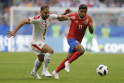 Costa Rica's Johan Venegas, right, vies for the ball with Serbia's Branislav Ivanovic during the group E match between Costa Rica and Serbia at the 2018 soccer World Cup in the Samara Arena in Samara, Russia, Sunday, June 17, 2018. (AP Photo/Natacha Pisarenko)