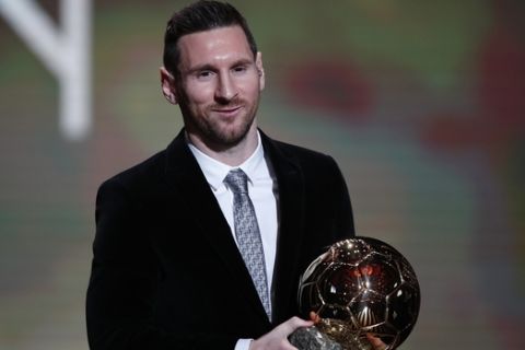 Barcelona's soccer player Lionel Messi holds the trophy of the Golden Ball award ceremony in Paris, Monday, Dec. 2, 2019. Messi won the Ballon d'Or for sixth time. (AP Photo/Francois Mori)