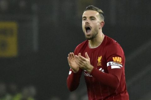 Liverpool's Jordan Henderson celebrates after scoring his side's opening goal during the English Premier League soccer match between Wolverhampton Wanderers and Liverpool at the Molineux Stadium in Wolverhampton, England, Thursday, Jan. 23, 2020. (AP Photo/Rui Vieira)