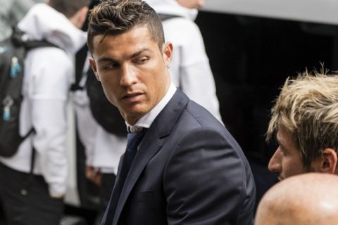 Real Madrid's Cristiano Ronaldo, left, and Fabio Coentrao arrive at the team hotel in Munich, southern Germany, Tuesday, April 11, 2017 one day before the Champions League first leg quarterfinal soccer match between Bayern Munich and Real Madrid. (Matthias Balk/dpa via AP)