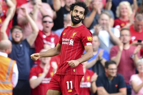 Liverpool's Mohamed Salah celebrates scoring during the English Premier League soccer match against Arsenal at Anfield, Liverpool, England, Saturday Aug. 24, 2019. (Anthony Devlin/PA via AP)