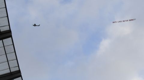 A plane towing a banner reading White Lives Matter Burnley flies above the stadium during the during the English Premier League soccer match between Manchester City and Burnley at Etihad Stadium, in Manchester, England, Monday, June 22, 2020. (AP Photo/Michael Regan,Pool)