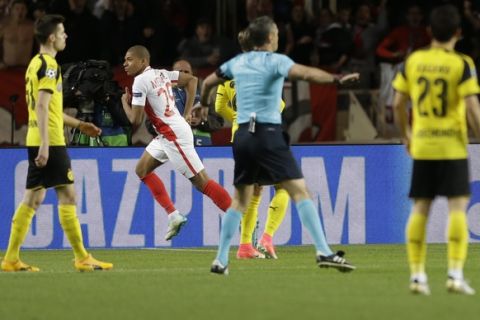 Monaco 's Kylian Mbappe, second left, runs after scoring his team opening goal during the Champions League quarterfinal second leg soccer match between Monaco and Dortmund at the Louis II stadium in Monaco, Wednesday April 19, 2017. (AP Photo/Claude Paris)