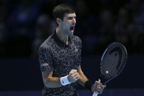 Novak Djokovic of Serbia celebrates winning a point against John Isner of the United States in their ATP World Tour Finals tennis match at the O2 Arena in London, Monday Nov. 12, 2018. (AP Photo/Tim Ireland)
