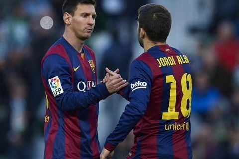 ELCHE, SPAIN - JANUARY 24:  Lionel Messi of Barcelona greets to teammate Jordi Alba during the La Liga match between Elche FC and FC Barcelona at Estadio Manuel Martinez Valero on January 24, 2015 in Elche, Spain.  (Photo by Manuel Queimadelos Alonso/Getty Images)