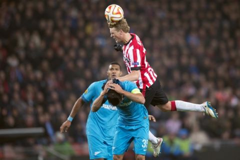 Danny of Zenit St. Petersburg, centre,  fights for the ball with Oscar Hiljemark,from PSV Eindhoven, during the first leg of the round of 32 Europa League match between PSV Eindhoven and Zenith St. Petersburg, at Philips stadium, in Eindhoven, Netherlands, Thursday Feb. 19, 2015. (AP Photo/Ermindo Armino)