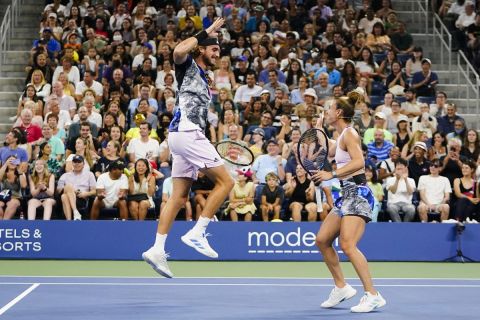 Stefanos Tsitsipas, left, and Maria Sakkari, of Greece, right, celebrate a point during  "The Tennis Plays for Peace" exhibition match to raise awareness and humanitarian aid for Ukraine Wednesday, Aug. 24, 2022, in New York. The 2022 U.S. Open Main Draw will begin on Monday, Aug. 29, 2022. (AP Photo/Frank Franklin II)