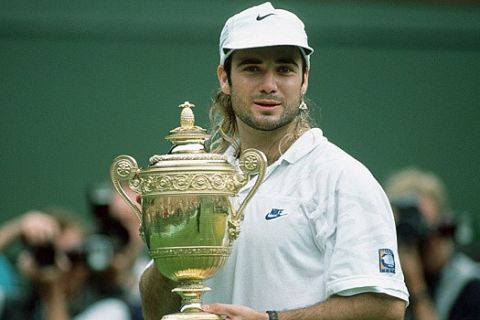 LONDON - JULY 5:  Andre Agassi of the USA celebrates with the trophy after the final match at the Wimbledon Tennis Championships at the All England Lawn Tennis Club on July 5, 1992 in London, United Kingdom. (Photo by Alexander Hassenstein/Bongarts/Getty Images)