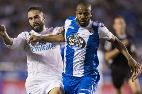 Real Madrid's Carbajal, left, fights for the ball with Deportivo's Sidnei during a Spanish La Liga soccer match at Riazor stadium in A Coruna, Spain, Sunday, Aug. 20, 2017. (AP Photo/Lalo R. Villar)