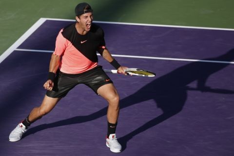 Thanasi Kokkinakis, of Australia, celebrates after defeating Roger Federer, of Switzerland, in a tennis match at the Miami Open, Saturday, March 24, 2018, in Key Biscayne, Fla. (AP Photo/Wilfredo Lee)