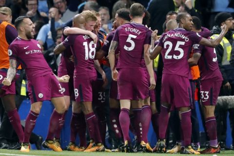 Manchester City's scorer Kevin De Bruyne, 3rd left, and his teammates celebrate the opening goal during their English Premier League soccer match between Chelsea and Manchester City at Stamford Bridge stadium in London, Saturday, Sept. 30, 2017. (AP Photo/Frank Augstein)
