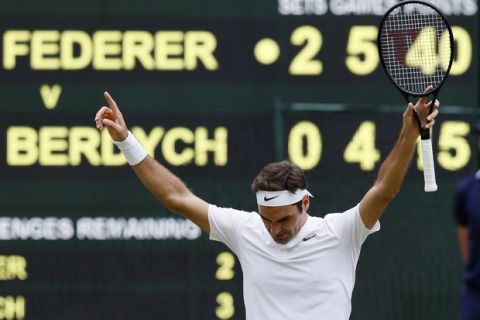 Switzerland's Roger Federer celebrates after beating Czech Republic's Tomas Berdych at the end of their Men's Singles semifinal match on day eleven at the Wimbledon Tennis Championships in London, Friday, July 14, 2017. (AP Photo/Kirsty Wigglesworth)