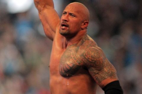 COMMERCIAL IMAGE - In this photograph taken by AP Images for WWE, Dwyane 'The Rock' Johnson celebrates after defeating John Cena at WrestleMania XXVIII in Sun Life Stadium on Sunday, April 1, 2012 in Miami. (Marc Serota/AP Images for WWE)