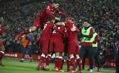 Liverpool players celebrate scoring their third goal during the English Premier League soccer match between Liverpool and Manchester City at Anfield Stadium, in Liverpool, England, Sunday Jan. 14, 2018. (AP Photo/Dave Thompson)