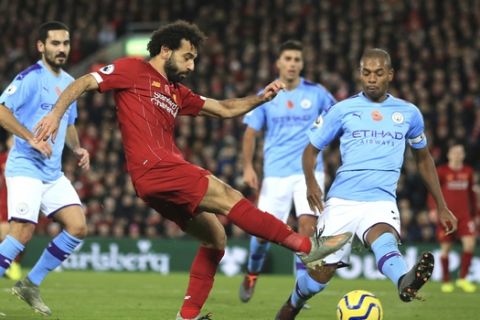 Liverpool's Mohamed Salah makes an attempt to score during the English Premier League soccer match between Liverpool and Manchester City at Anfield stadium in Liverpool, England, Sunday, Nov. 10, 2019. (AP Photo/Jon Super)