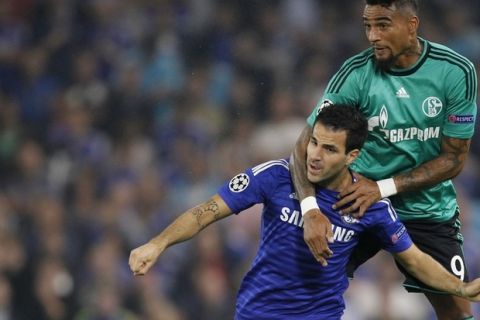 Schalkes midfielder Kevin-Prince Boateng (up) vies with Chelseas Spanish midfielder Cesc Fabregas during the UEFA Champions League, group G football match between Chelsea and Schalke 04 at Stamford Bridge, in London on September 17, 2014. AFP PHOTO / IAN KINGTON        (Photo credit should read IAN KINGTON/AFP/Getty Images)