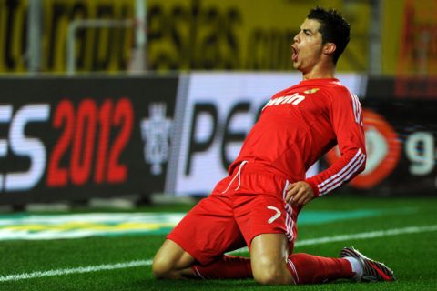 Real Madrid's Portuguese forward Cristiano Ronaldo celebrates after scoring against Sevilla during their Spanish League football match, on December 17, 2011 at Ramon Sanchez Pizjuan stadium in Sevilla.    AFP PHOTO/ JORGE GUERRERO (Photo credit should read Jorge Guerrero/AFP/Getty Images)