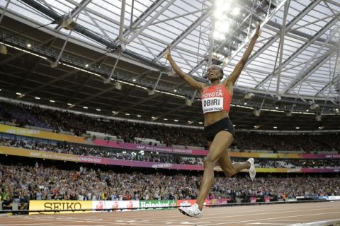 Kenya's Hellen Onsando Obiri celebrates after winning the gold medal as she crosses the finish line of the women's 5000-meter final during the World Athletics Championships in London Sunday, Aug. 13, 2017. (AP Photo/Matt Dunham)