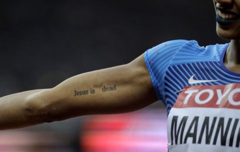 United States' Christina Manning shows off the tattoo on her arm after winning a Women's 100m hurdles semifinal during the World Athletics Championships in London Friday, Aug. 11, 2017. (AP Photo/David J. Phillip)