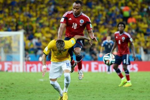 FORTALEZA, BRAZIL - JULY 04:  Neymar of Brazil is challenged by Juan Camilo Zuniga of Colombia during the 2014 FIFA World Cup Brazil Quarter Final match between Brazil and Colombia at Castelao on July 4, 2014 in Fortaleza, Brazil.  This tackle resulted in injury to Neymar and ended the player's World Cup. (Photo by Jamie McDonald/Getty Images)