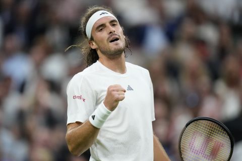 Stefanos Tsitsipas of Greece celebrates after winning the first set against Britain's Andy Murray in a men's singles match on day four of the Wimbledon tennis championships in London, Thursday, July 6, 2023. (AP Photo/Kirsty Wigglesworth)