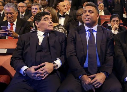 Argentinian soccer legend Diego Armando Maradona, left, sits beside Brazilian soccer legend Ronaldo during the The Best FIFA 2017 Awards at the Palladium Theatre in London, Monday, Oct. 23, 2017. (AP Photo/Alastair Grant)