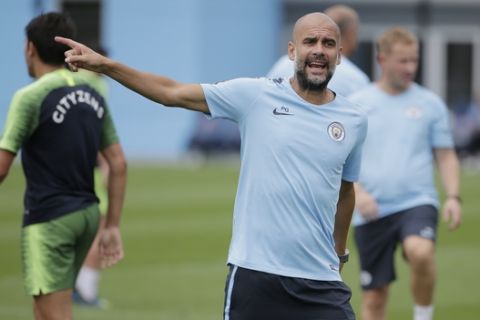 Manchester City Football Club's manager Pep Guardiola looks over the field during a practice in Orangeburg, N.Y., Monday, July 23, 2018. Manchester City is scheduled to play Liverpool in New Jersey on Wednesday, July 25, 2018. (AP Photo/Seth Wenig)