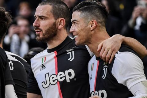 Juventus' Cristiano Ronaldo celebrates with teammate Gonzalo Higuain after scoring during an Italian Serie A soccer match between Juventus and Cagliari at the Allianz Stadium in Turin, Italy, Monday, Jan. 6, 2020. (Marco Alpozzi/LaPresse via AP)