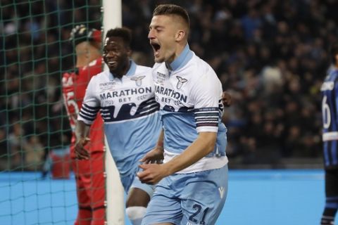Lazio's Sergej Milinkovic Savic, right, celebrates after scoring his side's opening goal during the Italian Cup soccer final match between Lazio and Atalanta, at the Rome Olympic stadium, Wednesday, May 15, 2019. (AP Photo/Alessandra Tarantino)