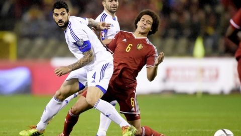 Cyprus' Giorgos Merkis (L) and Belgium's Axel Witsel (R) vie for the ball during a qualification game between Belgium and Cyprus at the King Baudouin stadium in Brussels on March 28, 2015.   AFP PHOTO / BELGA / YORICK JANSENS        (Photo credit should read YORICK JANSENS/AFP/Getty Images)