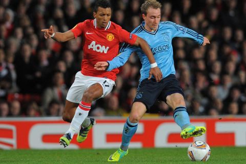 Ajax Amsterdam's Danish midfielder Christian Eriksen (R) vies with Manchester United's Portuguese midfielder Nani during an UEFA Europa League round of 32 second leg football match between Manchester United and Ajax at Old Trafford in Manchester, north-west England on February 23 2012. AFP PHOTO/ANDREW YATES (Photo credit should read ANDREW YATES/AFP/Getty Images)
