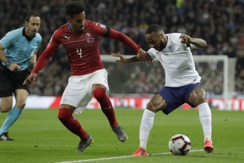 Czech Republic's Theodor Gebre Selassie left, challenges with England's Raheem Sterling during the Euro 2020 group a qualifying soccer match between England and the Czech Republic at Wembley stadium in London, Friday March 22, 2019. (AP Photo/Matt Dunham)