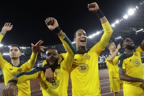 Celtic's Olivier Ntcham, second from left, celebrates with teammate after scoring his side's winning goal during an Europa League group E soccer match between Lazio and Celtic, in Rome's Olympic Stadium, Thursday, Nov. 7, 2019. Celtics won 2-1. (AP Photo/Gregorio Borgia)