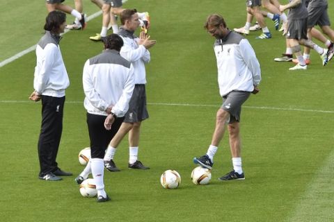 Liverpool's coach Juergen Klopp, center, touches the ball during the last training session prior the Europa League final between Liverpool FC and Sevilla FC in Basel, Switzerland, Tuesday, May 17, 2016. (AP Photo/Martin Meissner)