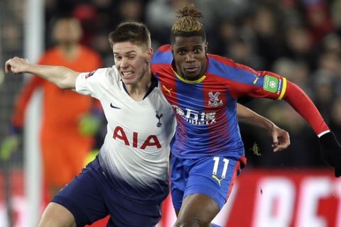 Tottenham's Juan Foyth fights for the ball with Crystal Palace's Wilfried Zaha, right, during an English FA Cup fourth round soccer match between Crystal Palace and Tottenham Hotspur at Selhurst Park in London, Sunday, Jan. 27, 2019. (AP Photo/Tim Ireland)