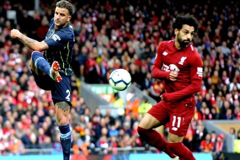 Manchester City's Kyle Walker clears the ball before Liverpool's Mohamed Salah can get to it during the English Premier League soccer match between Liverpool and Manchester City at Anfield stadium in Liverpool, England, Sunday, Oct. 7, 2018. (AP Photo/Rui Vieira)