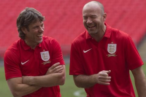 British comedian John Bishop, left, jokes with former premier soccer player Alan Shearer ahead of the celebrity soccer match between Nick Grimshaw's team Radio One-derers and Olly Murs' team Tottenham Hot-murs, at Wembley Stadium in London, Tuesday, Dec. 10, 2013. (Photo by Joel Ryan/Invision/AP)