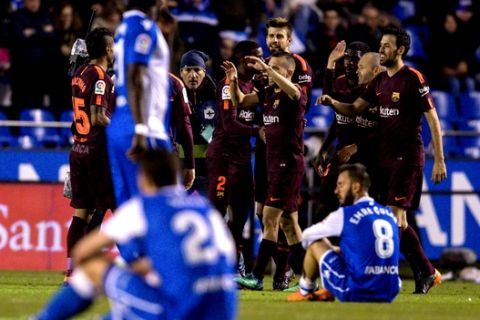 Barcelona's players celebrate after winning the 2017-18 Spanish La Liga at the end of the soccer match between Deportivo and Barcelona at the Riazor stadium in A Coruna, Spain, Sunday, April 29, 2018. (AP Photo/Lalo R. Villar)