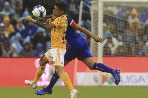 Tigres' Javier Aquino, front, fights for the ball with Cruz Azul's Gerardo Floes during a Mexico soccer league match in Mexico City, Saturday, Aug. 4, 2018. (AP Photo/Christian Palma)