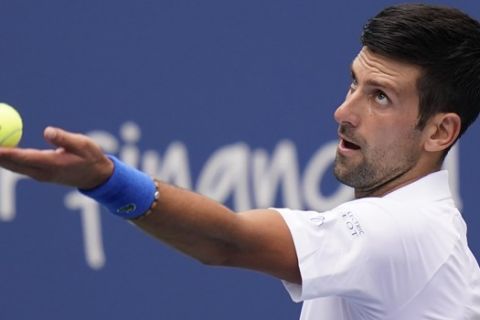 Novak Djokovic, of Serbia, serves to Roberto Bautista Agut, of Spain, during the semifinals at the Western & Southern Open tennis tournament Friday, Aug. 28, 2020, in New York. (AP Photo/Frank Franklin II)