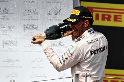 BUDAPEST, HUNGARY - JULY 24: Lewis Hamilton of Great Britain and Mercedes GP celebrates his win on the podium during the Formula One Grand Prix of Hungary at Hungaroring on July 24, 2016 in Budapest, Hungary.  (Photo by Mark Thompson/Getty Images)