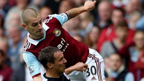 LONDON, ENGLAND - SEPTEMBER 21: Mladen Petric of West Ham tackles Phil Jagielka of Everton during the Barclays Premier League match between West Ham United and Everton at the Boleyn Ground on September 21, 2013 in London, England. (Photo by Ian Walton/Getty Images)