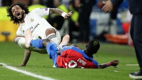 Real defender Marcelo, left, duels for the ball with Plzen midfielder Ubong Ekpai during a Group G Champions League soccer match between Real Madrid and Viktoria Plzen at the Santiago Bernabeu stadium in Madrid, Spain, Tuesday Oct. 23, 2018. (AP Photo/Manu Fernandez)