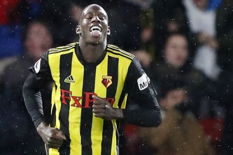 Watford's Abdoulaye Doucoure celebrates after scoring his side's opening goal during the English Premier League soccer match between Watford and Manchester City at Vicarage Road stadium in Watford, England, Tuesday, Dec. 4, 2018. (AP Photo/Frank Augstein)