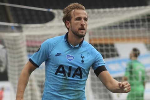 Tottenham's Harry Kane celebrates after scoring his side's second goal during the English Premier League soccer match between Newcastle United and Tottenham Hotspur at St. James' Park in Newcastle, England, Wednesday, July 15, 2020. (Owen Humphreys/Pool via AP)