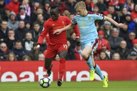 Liverpool's Sadio Mane, left, and Burnley's Ben Mee battle for the ball during the English Premier League soccer match at Anfield, Liverpool, England, Sunday March 12, 2017. (Peter Byrne/PA via AP)