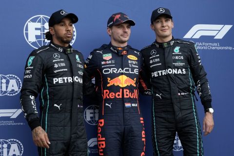 The first three finishers of the qualifying run of the Formula One Mexico Grand Prix, left, Mercedes driver Lewis Hamilton, of Britain, third, Mercedes driver George Russell, of Britain, second, and pole position Red Bull driver Max Verstappen, of the Netherlands, center, pose for photos at the Hermanos Rodriguez racetrack in Mexico City, Saturday, Oct. 29, 2022. (AP Photo/Moises Castillo)