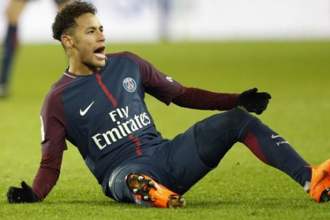PSG's Neymar reacts after falling during the French League One soccer match between Paris Saint Germain and Strasbourg, at the Parc des Princes stadium in Paris, France, Saturday, Feb. 17, 2018. (AP Photo/Francois Mori)