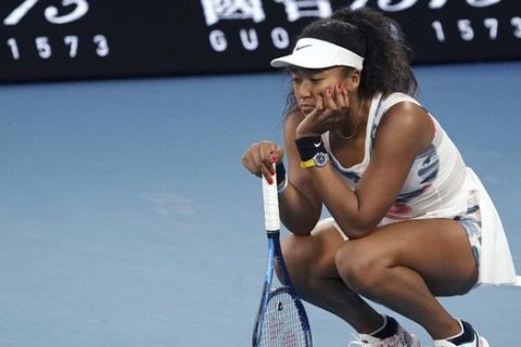 Japan's Naomi Osaka reacts during her third round loss to Coco Gauff of the U.S. at the Australian Open tennis championship in Melbourne, Australia, Friday, Jan. 24, 2020. (AP Photo/Lee Jin-man)