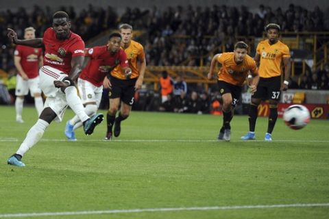Manchester United's Paul Pogba, left, fails to score penalty shot during the English Premier League soccer match between Wolverhampton Wanderers and Manchester United at the Molineux Stadium in Wolverhampton, England, Monday, Aug. 19, 2019. (AP Photo/Rui Vieira)